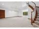 Finished basement with a wooden staircase and backyard access at 96 Falcon Hills Dr, Highlands Ranch, CO 80126