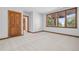 Spacious bedroom featuring soft carpeting, natural light, and classic wood trim at 96 Falcon Hills Dr, Highlands Ranch, CO 80126