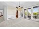 Elegant dining room featuring a stylish chandelier, wainscoting detail and access to the outdoor balcony at 96 Falcon Hills Dr, Highlands Ranch, CO 80126