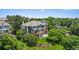 Beautiful backyard featuring multilevel decks and stone columns, surrounded by lush trees at 96 Falcon Hills Dr, Highlands Ranch, CO 80126