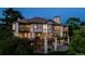 Large home with multiple decks, stone supports, and many windows for natural light at 96 Falcon Hills Dr, Highlands Ranch, CO 80126