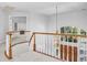 Bright foyer features a curved staircase, white railings, and an elegant hanging light fixture over the front door at 96 Falcon Hills Dr, Highlands Ranch, CO 80126