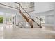 Expansive foyer featuring a sweeping staircase, tile floors, and abundant natural light at 96 Falcon Hills Dr, Highlands Ranch, CO 80126