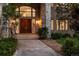 Stately home showcasing a grand double-door entrance with detailed stonework and landscaping at 96 Falcon Hills Dr, Highlands Ranch, CO 80126