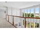 Bright upstairs hallway with beautiful views of the neighborhood and yard through large windows at 96 Falcon Hills Dr, Highlands Ranch, CO 80126