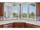 Cozy kitchen nook boasts a bay window with wooded views, and custom cabinets at 96 Falcon Hills Dr, Highlands Ranch, CO 80126