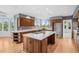 Expansive kitchen with hardwood floors, a large island, a prep sink and large windows at 96 Falcon Hills Dr, Highlands Ranch, CO 80126