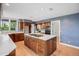 Spacious kitchen features hardwood floors, a large island and custom cabinets at 96 Falcon Hills Dr, Highlands Ranch, CO 80126