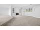 Large carpeted living room with a fireplace, built-in shelves, and a bay window at 96 Falcon Hills Dr, Highlands Ranch, CO 80126