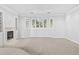 Bright living room features a fireplace, built-in shelves, and a bay window with natural light at 96 Falcon Hills Dr, Highlands Ranch, CO 80126