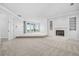 Large open-concept living room features a fireplace, built-in shelves, and access to a balcony at 96 Falcon Hills Dr, Highlands Ranch, CO 80126