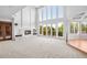 Bright living room with a fireplace, built-in shelves, and large windows with outdoor views at 96 Falcon Hills Dr, Highlands Ranch, CO 80126