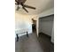Bedroom with desk, ceiling fan and access to closet and laundry at 5255 Memphis St # 121, Denver, CO 80239