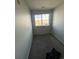 Empty bedroom with carpet flooring and a window overlooking the outdoors at 5255 Memphis St # 121, Denver, CO 80239
