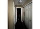Hallway view with white doors, and a view to another room at 5255 Memphis St # 121, Denver, CO 80239
