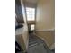Carpeted staircase with a large window providing natural light at 5255 Memphis St # 121, Denver, CO 80239