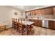 Eat-in kitchen with stainless steel appliances, wood cabinets, and a large dining table for gatherings at 107 Skiwatch Dr # 329, Breckenridge, CO 80424