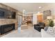 Open-concept living area showcasing a stone fireplace, comfortable seating, and a view into the kitchen at 107 Skiwatch Dr # 329, Breckenridge, CO 80424