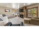 Cozy living room with stone fireplace, plush seating, and scenic views from large windows and balcony at 107 Skiwatch Dr # 329, Breckenridge, CO 80424