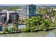 Modern building with lush green trees, a tennis court, and a serene waterfront view, offering a blend of recreation and relaxation at 4200 W 17Th Ave # 611, Denver, CO 80204