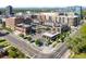 Aerial view of modern townhomes with rooftop patios near a busy city street with restaurants and shops at 4200 W 17Th Ave # 611, Denver, CO 80204