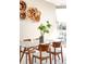 Dining room with a modern glass table, stylish chairs, and decorative wall art at 4200 W 17Th Ave # 611, Denver, CO 80204