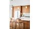 Stylish kitchen with wooden cabinets, a large center island, and pendant lighting at 4200 W 17Th Ave # 611, Denver, CO 80204