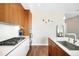 Modern kitchen showcasing a gas range, white countertops, and sleek wooden cabinetry at 4200 W 17Th Ave # 611, Denver, CO 80204