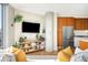 Bright living room with a TV, modern appliances, hardwood floors, and stylish decor at 4200 W 17Th Ave # 611, Denver, CO 80204