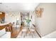 Open-concept living area connecting the kitchen and dining space with hardwood floors at 4200 W 17Th Ave # 611, Denver, CO 80204