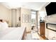 Bedroom with modern fireplace, TV, and view to the balcony at 4200 W 17Th Ave # 611, Denver, CO 80204