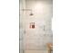 Beautifully tiled shower featuring a niche for toiletries and a glass door at 4200 W 17Th Ave # 611, Denver, CO 80204