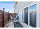 Back patio with privacy fence, seating, and sliding door entrance to townhome unit, with 'C' posted near entry at 3355 Talisman Ct # C, Boulder, CO 80301