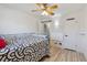 Bedroom features a ceiling fan, vinyl wood flooring, and mounted wall heater at 3355 Talisman Ct # C, Boulder, CO 80301