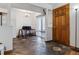 Open-concept entryway with stone tile, wooden door, transitioning to kitchen and dining area with bar stool seating at 3355 Talisman Ct # C, Boulder, CO 80301