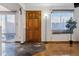 Open entryway with hardwood and tile flooring, a wooden front door, and windows for ample natural light at 3355 Talisman Ct # C, Boulder, CO 80301