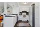 Modern kitchen features stainless steel appliances, white cabinetry, and tiled flooring at 3355 Talisman Ct # C, Boulder, CO 80301