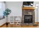 Bright living room space with fireplace, flatscreen TV, desk area, and hardwood floors for modern living at 3355 Talisman Ct # C, Boulder, CO 80301
