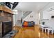 Bright living room with fireplace, flatscreen TV, hardwood floors, plus adjacent access to stairs and bathroom at 3355 Talisman Ct # C, Boulder, CO 80301