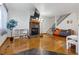 Bright living room with hardwood floors, fireplace and flatscreen TV, leading to carpeted stairs with black railing at 3355 Talisman Ct # C, Boulder, CO 80301