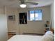 Bright bedroom featuring a ceiling fan and large window for natural light at 1833 N Williams St # 507, Denver, CO 80218