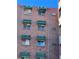 Brick building with windows, air conditioning units, and green and white striped awnings at 1833 N Williams St # 507, Denver, CO 80218