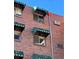 Brick building exterior with striped window awnings and a 'For Rent' sign at 1833 N Williams St # 507, Denver, CO 80218