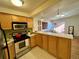 Bright kitchen open to the living room with stainless appliances and a breakfast bar at 1833 N Williams St # 507, Denver, CO 80218