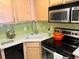 Well-lit kitchen with stainless steel appliances and trendy green backsplash at 1833 N Williams St # 507, Denver, CO 80218
