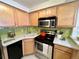 Efficient kitchen with stainless steel appliances and bright, light wood cabinets at 1833 N Williams St # 507, Denver, CO 80218