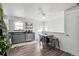 Well-lit kitchen with stainless steel appliances, dark countertops and hardwood floors at 6922 Vance St, Arvada, CO 80003