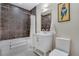 Comfortable bathroom with dark tiled shower, white sink, and a framed picture on the wall at 410 Acoma St # 515, Denver, CO 80204