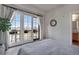 Bedroom featuring a large window leading to a balcony and a glimpse into an adjacent bathroom at 410 Acoma St # 515, Denver, CO 80204
