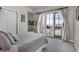 Bedroom featuring a large bed, sliding door access to balcony, and modern design elements at 410 Acoma St # 515, Denver, CO 80204